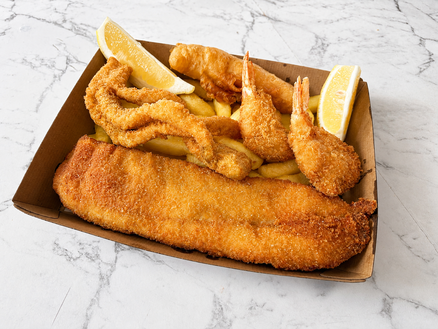 Seafood selection with chips and lemon