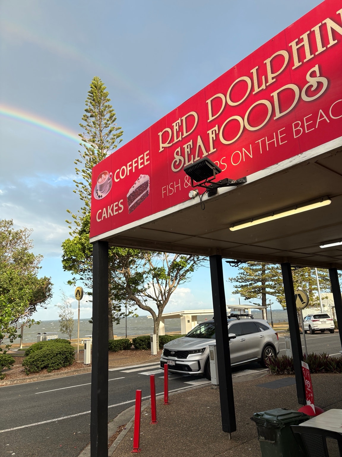 Red Dolphin Seafoods sign with rainbow